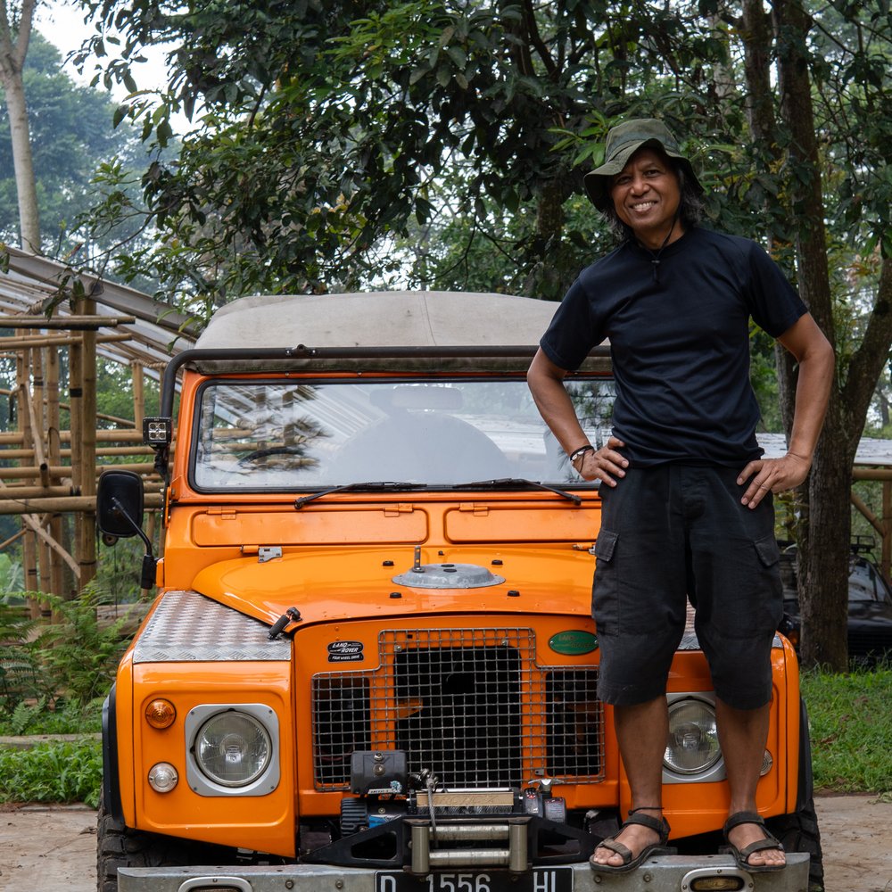 Guide standing on the Land Rover used for forest tours