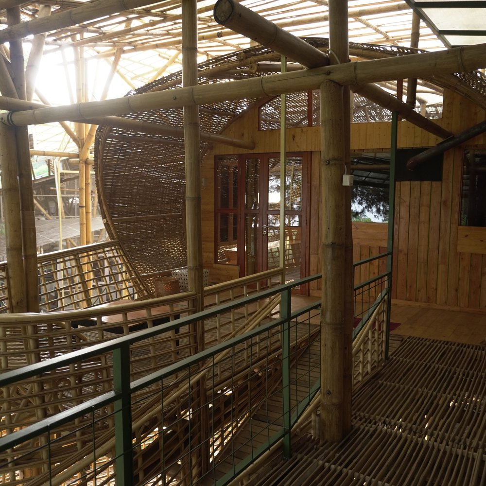 A curved bamboo balcony and guest room entrance