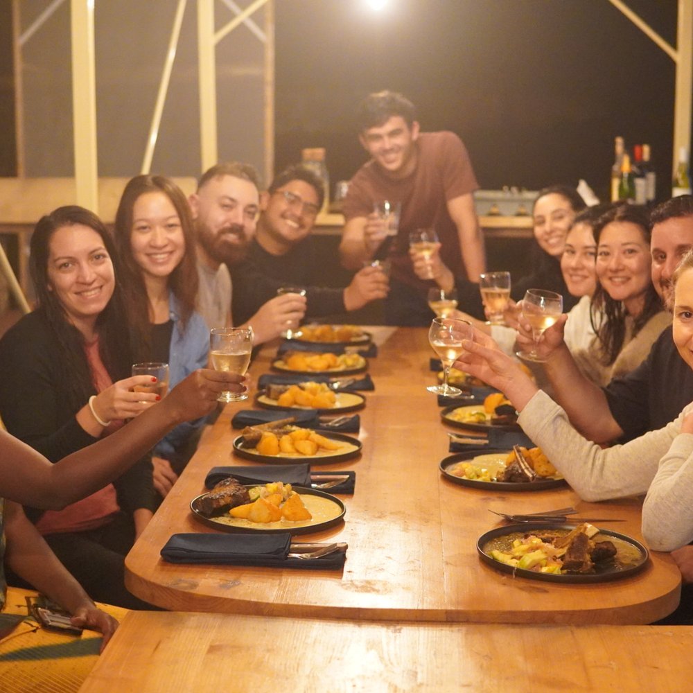 Guests raising a toast at a shared feast